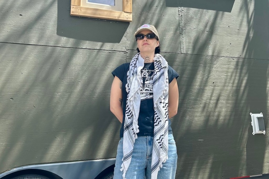 Gina Mowatt standing in front of the tiny home.