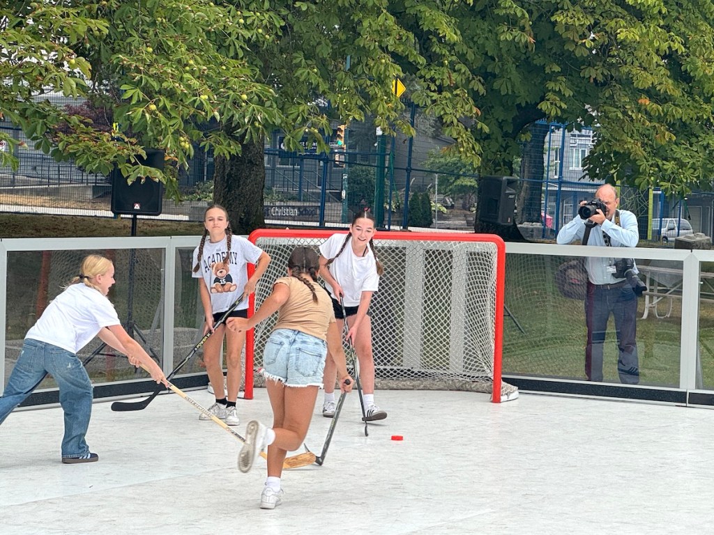 Girls play street hockey in a new Big Backyard "free play zone" at the PNE fair site in Vancouver on Aug. 14. 2025.