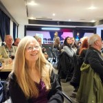 Karen Long watches the votes being counted with supporters around her in Aldergrove.