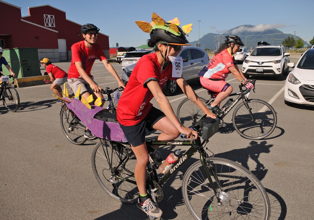 A cyclist with a dinosaur costume leaves Chilliwack Heritage Park while taking part in the 60-kilometre route of the MS Bike Chilliwack fundraiser for multiple sclerosis on Saturday, July 12, 2025.