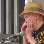 Rod Cunningham plays harmonica during the Buddy Up program finale at the Pioneer Senior Centre.