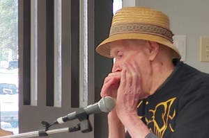 Rod Cunningham plays harmonica during the Buddy Up program finale at the Pioneer Senior Centre.