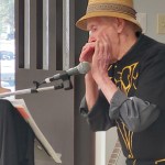Rod Cunningham plays harmonica during the Buddy Up program finale at the Pioneer Senior Centre.
