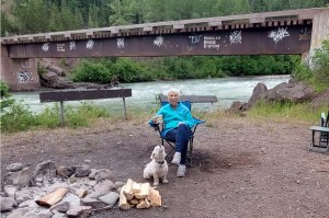 Cathy Ismond enjoys the Telkwa River forest service campsite with Sonja Lester's dog.