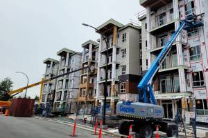 Construction workers with lifts at the site of the 330-unit Inspire condominium development in downtown Maple Ridge. (Neil Corbett/The News)
