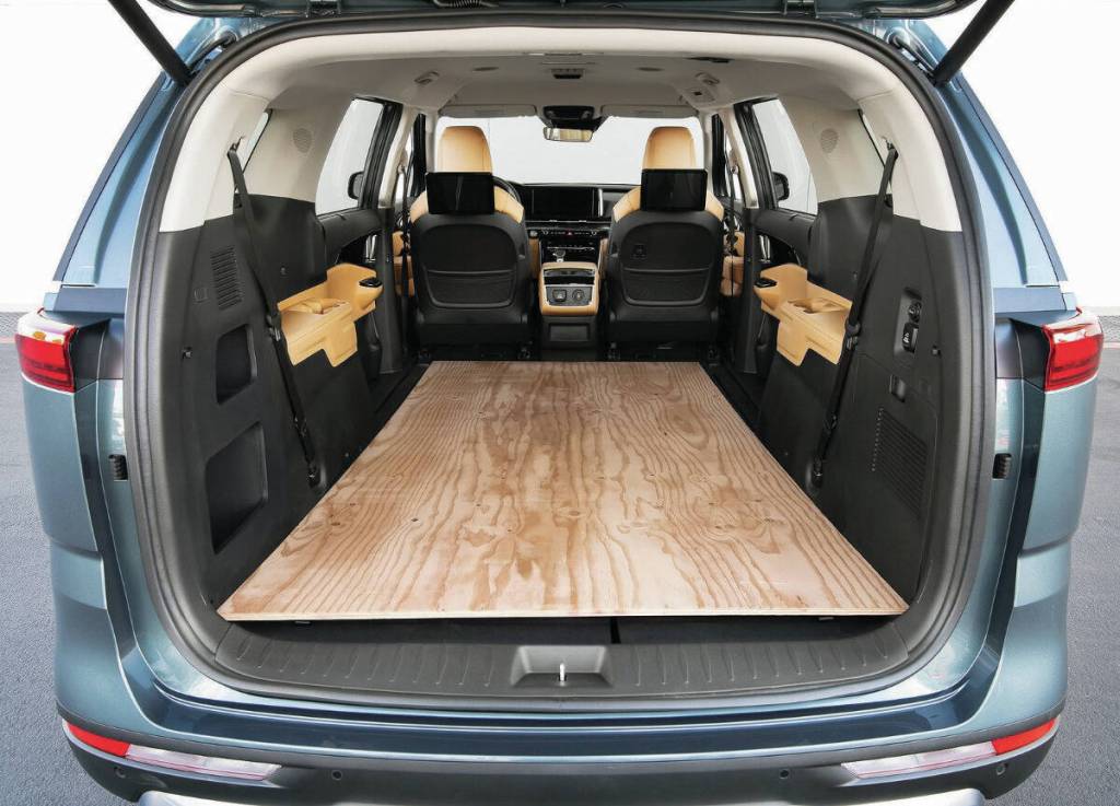 One common benchmark between competing minivans is that 4x8 sheets of building material must fit inside with the rear door closed. PHOTO: KIA