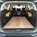 One common benchmark between competing minivans is that 4x8 sheets of building material must fit inside with the rear door closed. PHOTO: KIA
