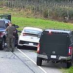 Two black unmarked RCMP vehicles block in a white Hyundai driven by a suspect who allegedly picked up three border-jumpers in Abbotsford on Oct. 8. (BC RCMP photo)