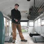 Turi Duhamel, 17, with the School District 19 bus he bought and is converting into a camper and workshop for his Revelstoke Secondary School capstone project, pictured Wednesday, Oct. 29. (Evert Lindquist/Revelstoke Review)