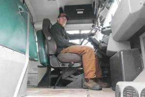 Turi Duhamel, 17, with the School District 19 bus he bought and is converting into a camper and workshop for his Revelstoke Secondary School capstone project, pictured Wednesday, Oct. 29. (Evert Lindquist/Revelstoke Review)